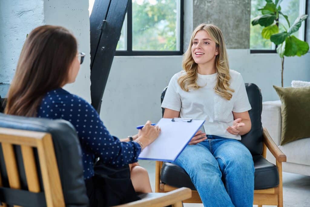 Smiling,Happy,Young,Woman,At,Session,With,Psychologist,,Therapist